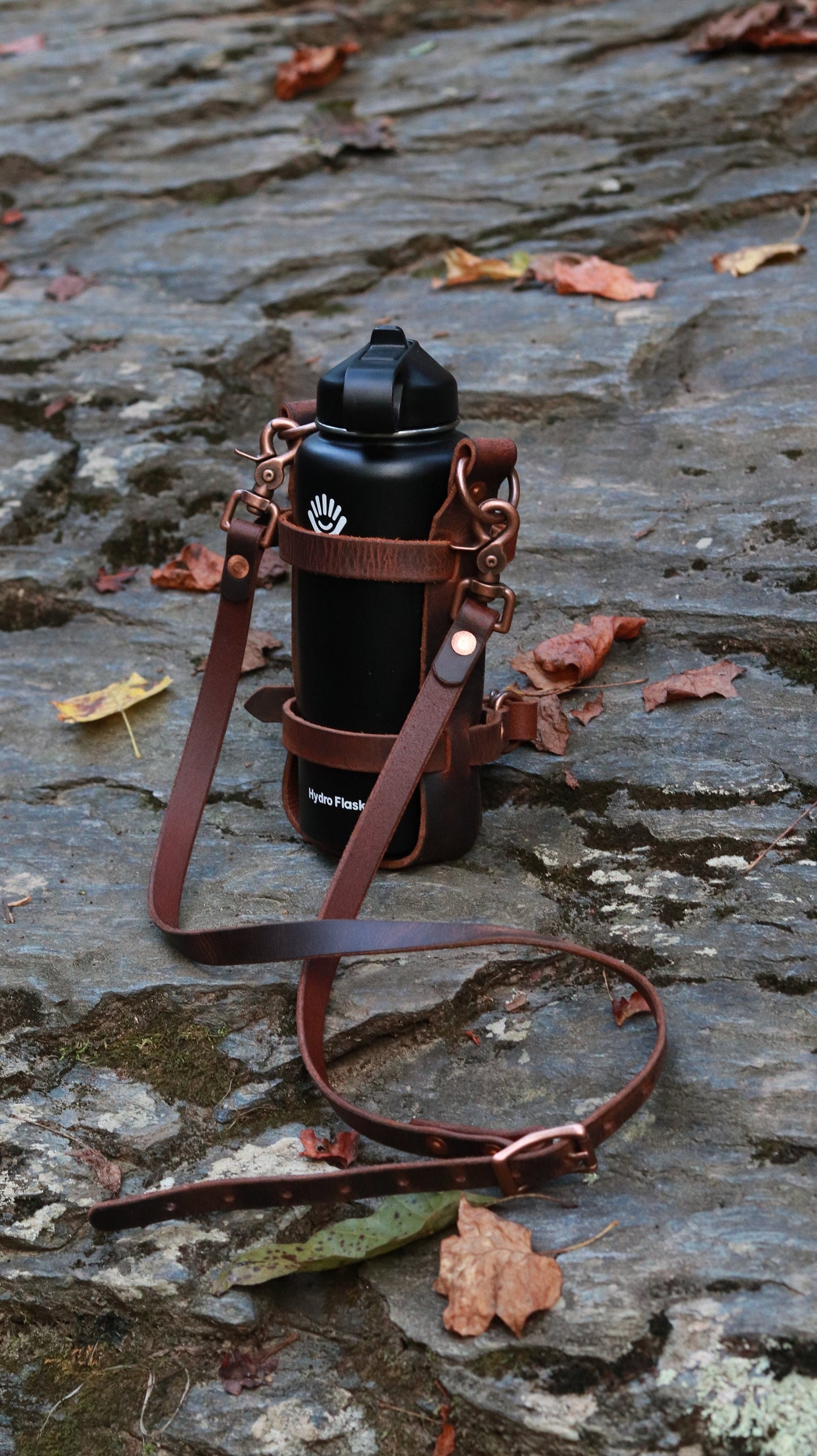 Adjustable Full Grain Water Buffalo leather water bottle carrier with shoulder strap, antique copper hardware, can be made to fit any bottle